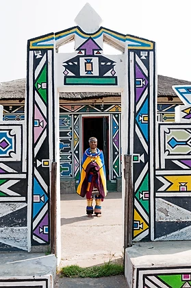 Full-length portrait of Esther Mahlangu in an Ndebele doorway, by Clint Strydom