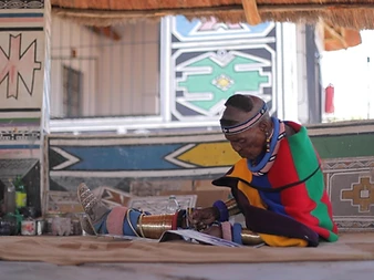 Dr Esther Mahlangu painting the bespoke Phantom Gallery panel at her homestead
