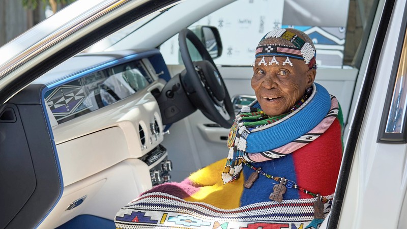 Dr Esther Mahlangu seated inside the bespoke Rolls-Royce Phantom, featuring her hand-painted Ndebele artwork in the Gallery. Photo: Willie Botes