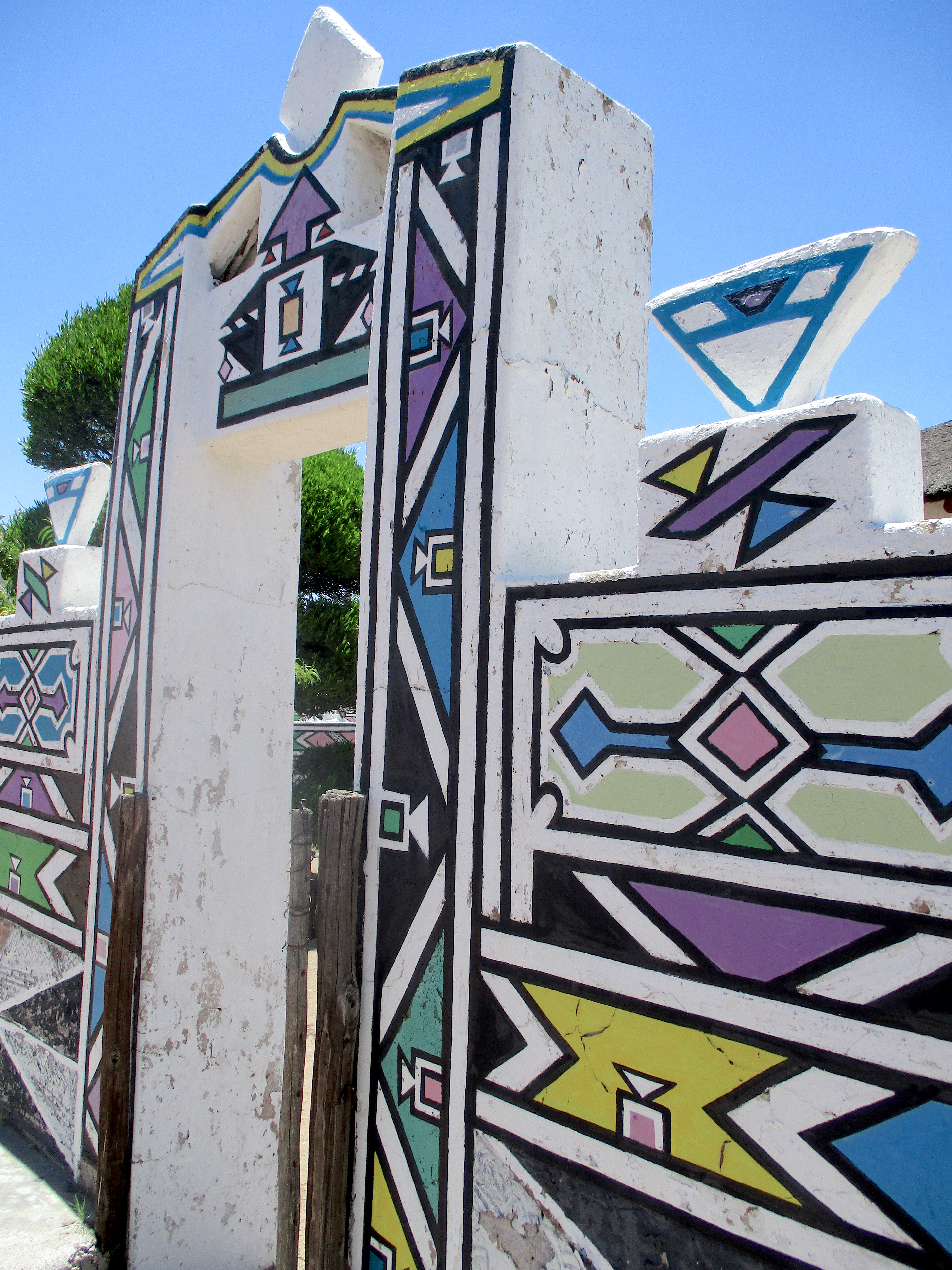 Traditional Ndebele gateway and painted mural wall