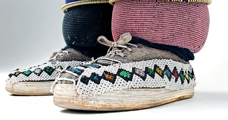 Dr Esther Mahlangu's beaded sneakers and leg rings, a detail portrait by Clint Strydom