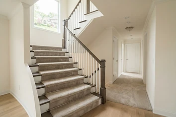 Newly installed carpet on a staircase and hallway in a Michigan home