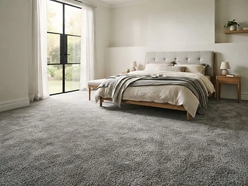 Plush grey carpet installed in a Sterling Heights bedroom by Quick Carpet