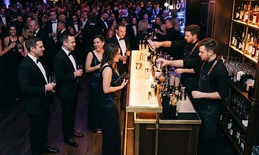 Bartender serving guests at a corporate gala