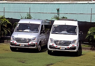 Silver and white passenger vans parked side by side