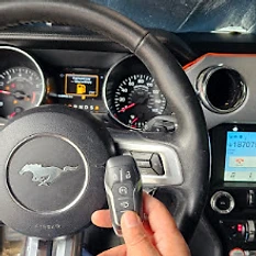 Ford Mustang smart key fob held at the steering wheel