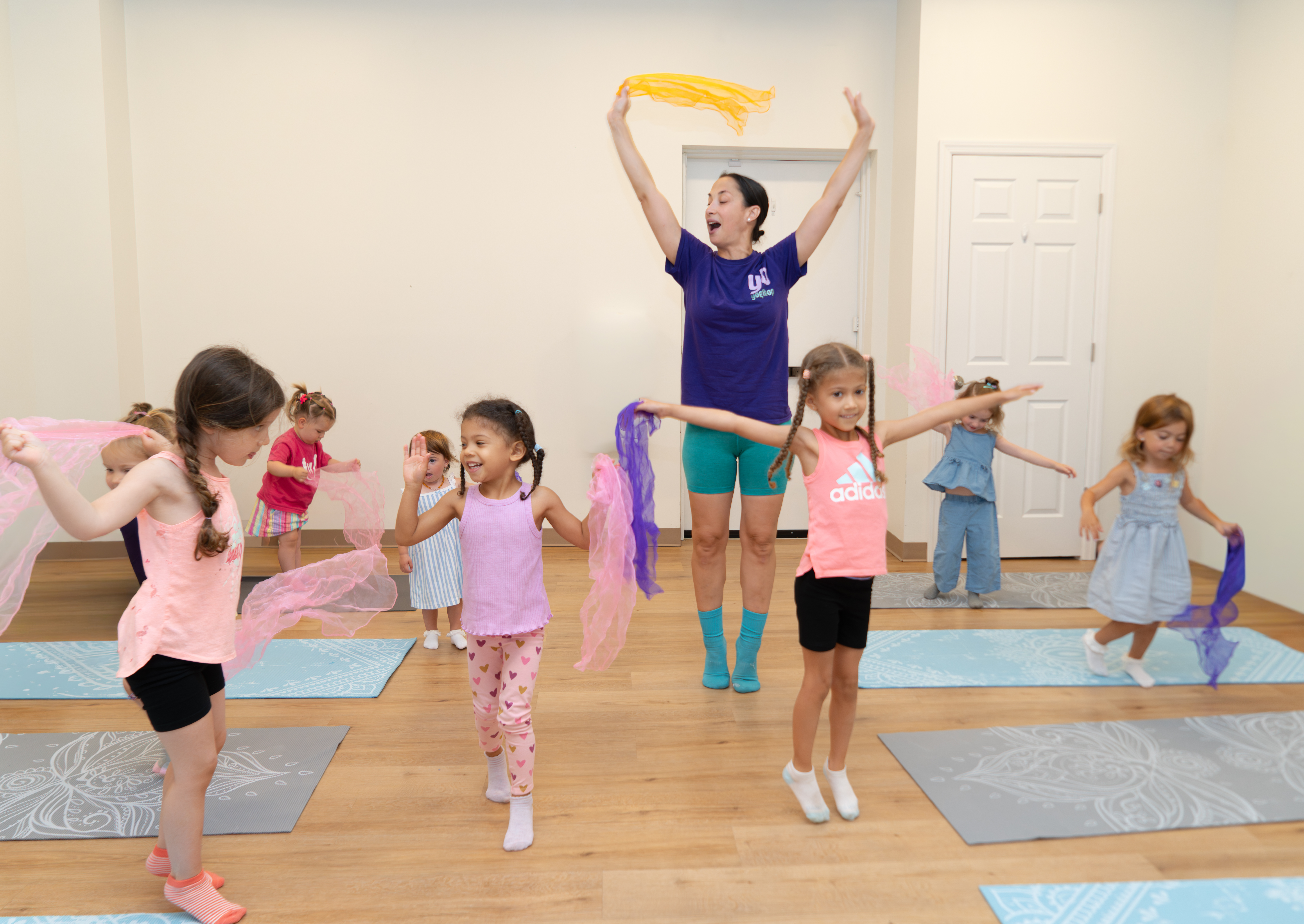 Children practicing yoga in a bright studio