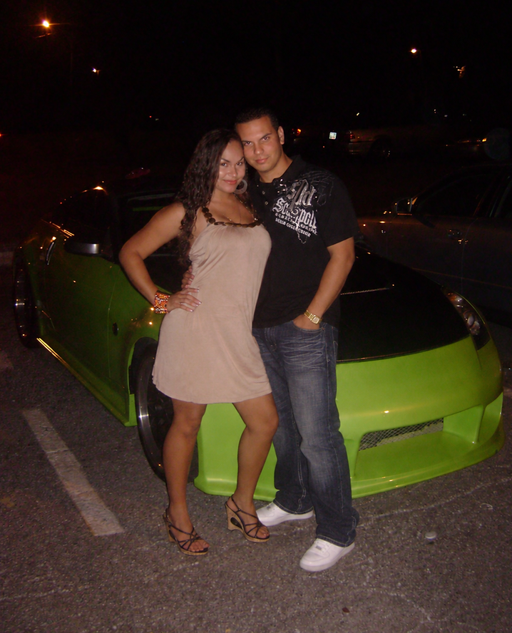 Stephanie and Nando standing beside Nando's lime-green Nissan 350Z, known as Coquí, in a parking lot at night