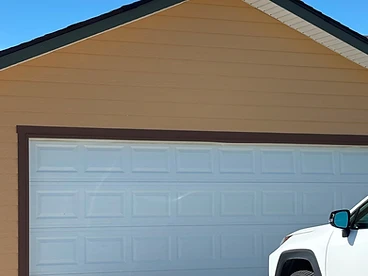 New white sectional garage door installed by M Garage Door Repair in Fort Collins, Colorado