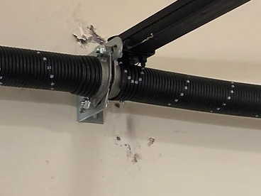 Torsion spring replacement on a residential garage door in Fort Collins