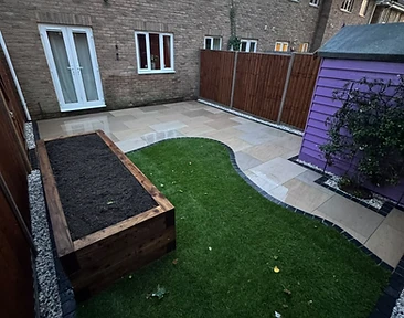 Finished porcelain patio with charcoal border, sleeper bed and artificial turf by CG Landscaping