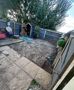 Garden before renovation — bare soil, old deck and weathered fence