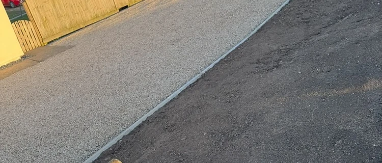 Freshly laid gravel driveway with clean edging by CG Landscaping