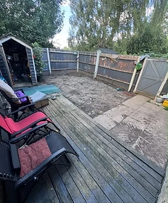 Garden before renovation — exposed earth, aged decking and old fencing