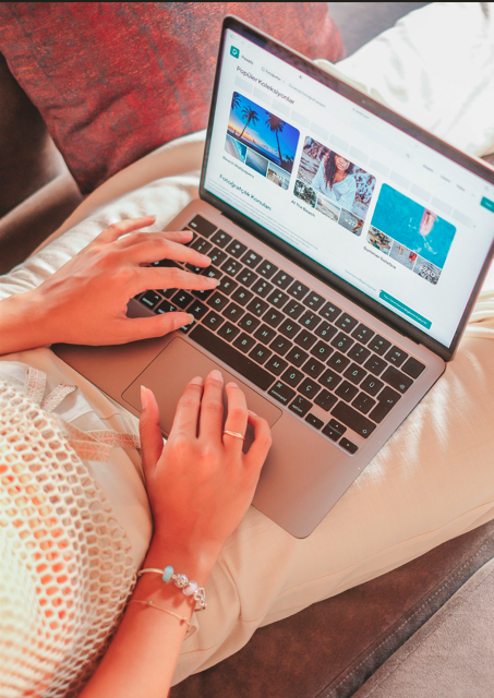A hand on a laptop keyboard, clean natural nails, no oily sheen on the screen.
