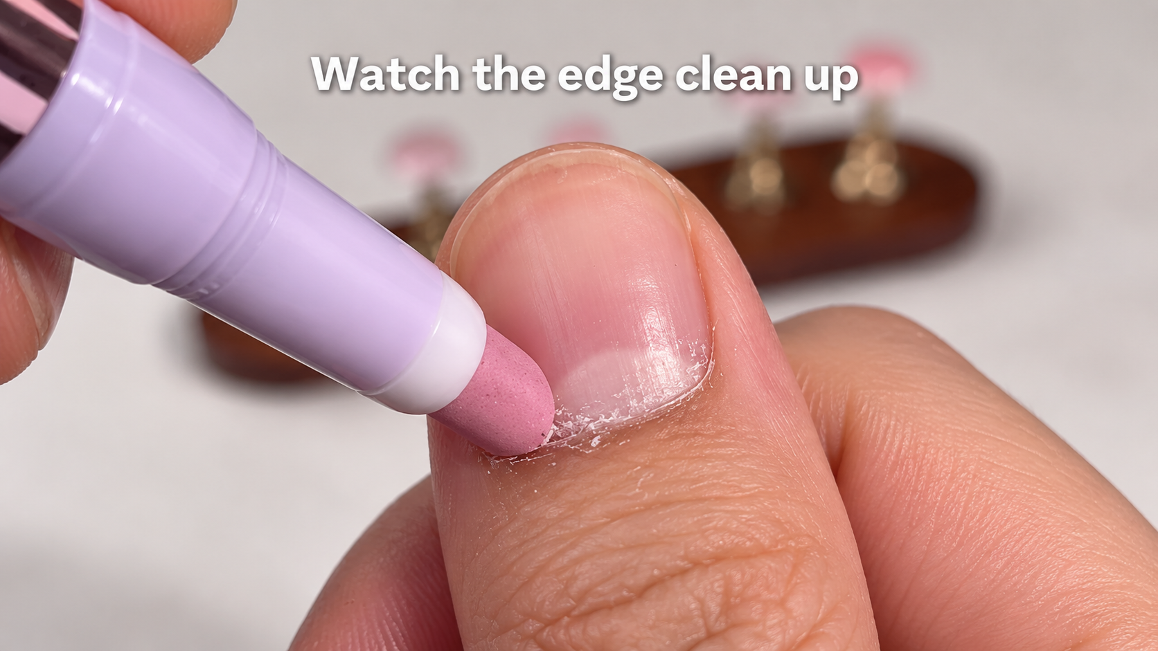The VELLUVA pen gliding along the edge of a nail, smoothing the dry edge, close and warm.