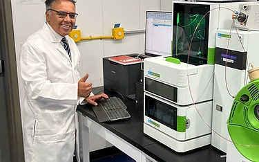 Researcher giving thumbs up in the lab