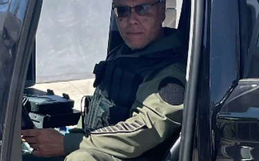Operator in tactical gear in vehicle