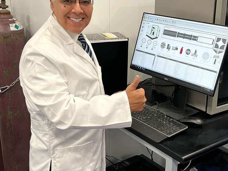 Researcher in lab coat at the LC-MS bench