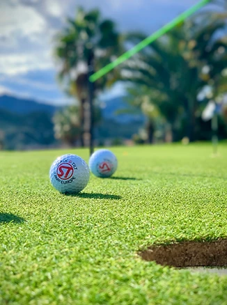 Stack&Tilt golf balls arranged beside a green putting string line