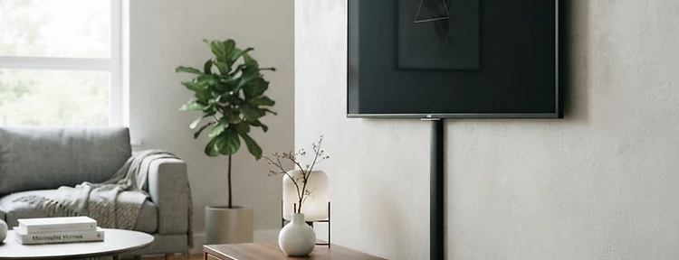 Neat black or white D-profile paintable cable ducting concealing TV wires down a plaster wall