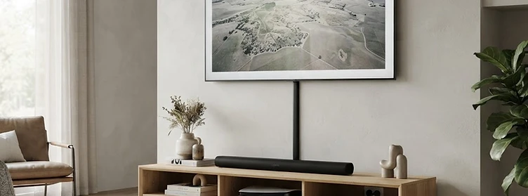 Wall-mounted TV above a media unit with slim black D-profile cable ducting concealing wires
