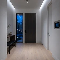 Minimal entry hallway with a flush-mounted security panel