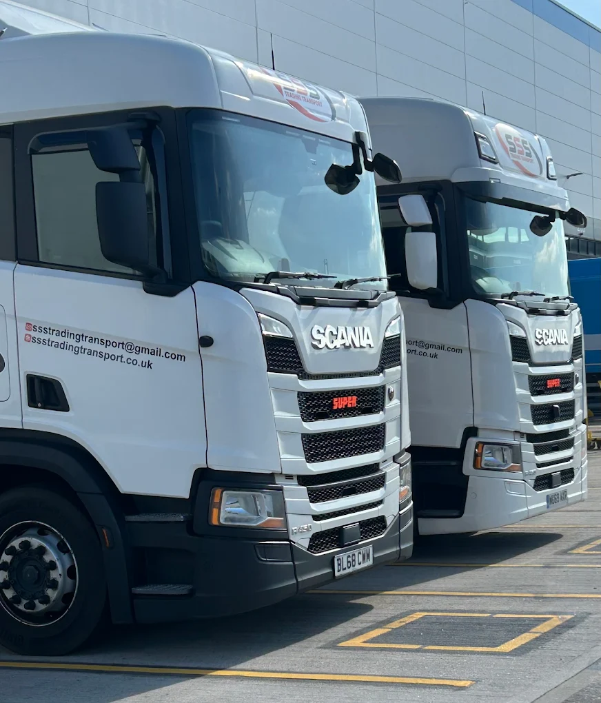 Two white Scania R450 trucks parked at BHX8 distribution terminal