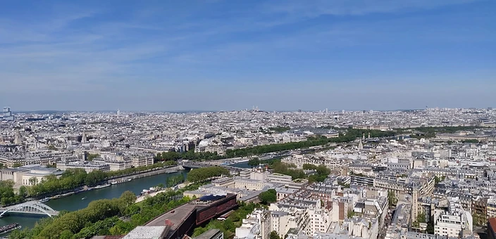 Aerial panoramic view of Paris rooftops, the Seine, and the skyline — discovered by Denoxa Adventures students