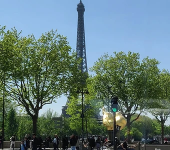The Eiffel Tower and the Flame of Liberty on a sunny day in Paris
