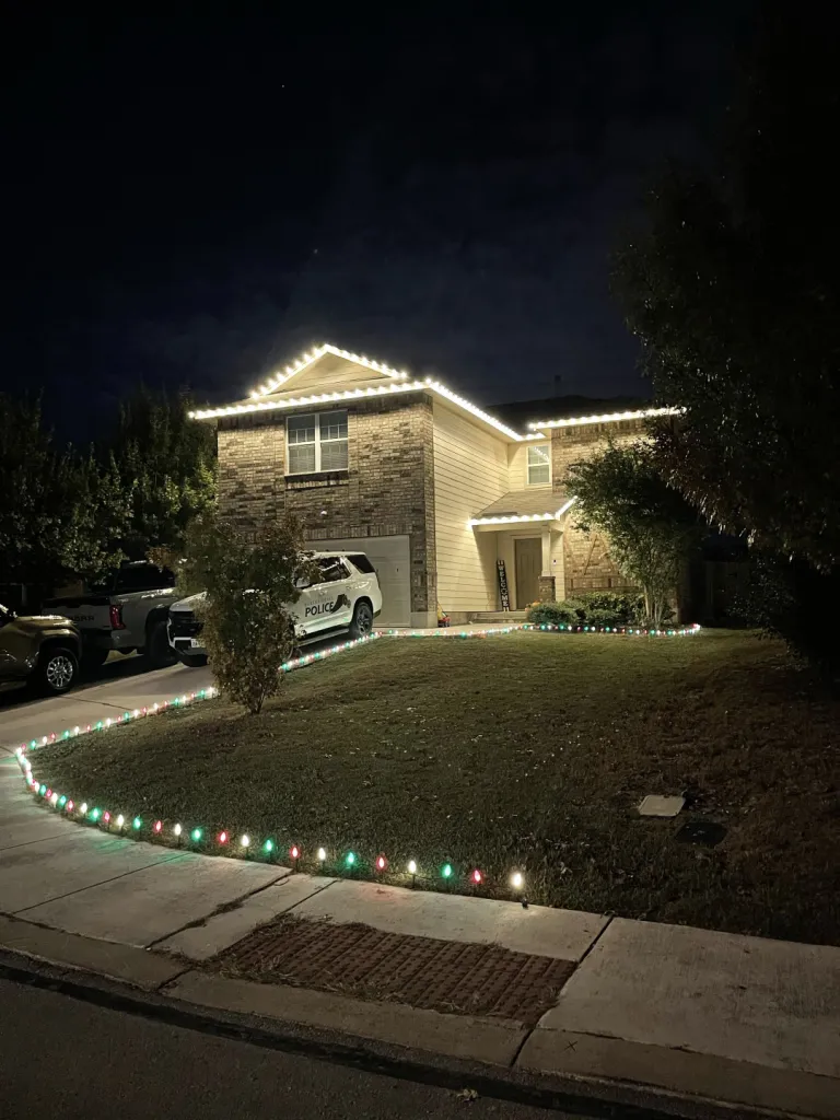 Warm White Stone Home with Lawn Lights, full property holiday lighting installation by Brilliance Lighting