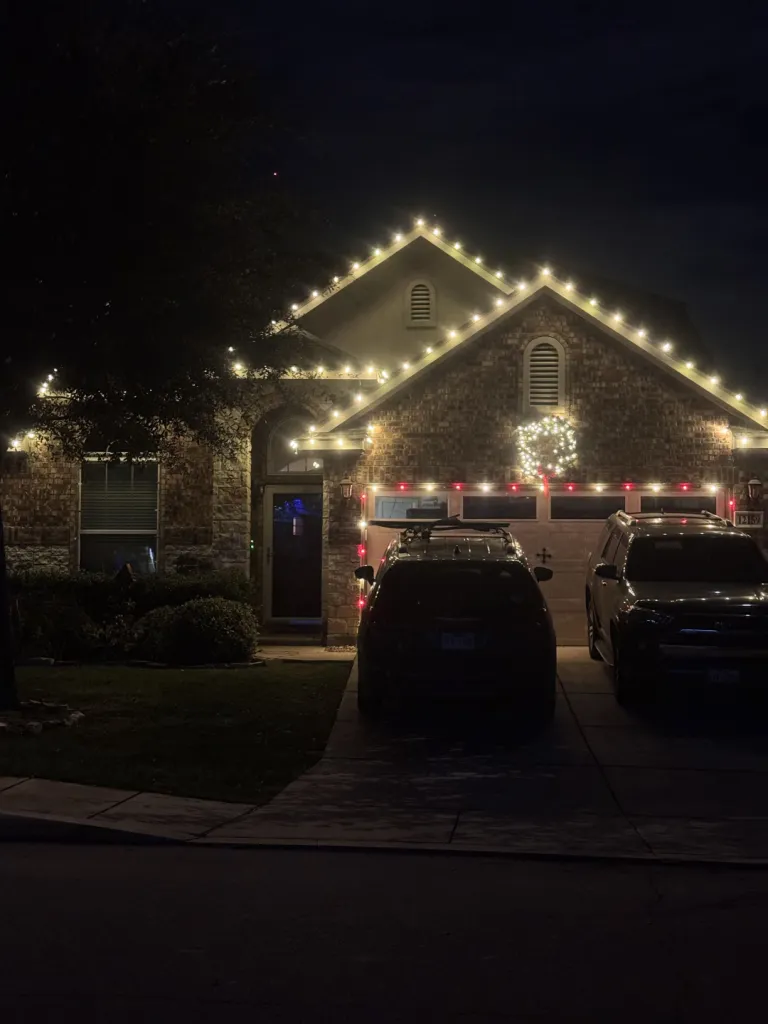 Red and White Gabled Roofline, multicolor holiday lighting installation by Brilliance Lighting
