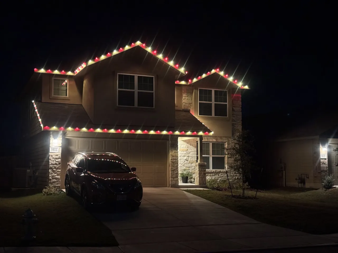 Red and Green Two Story Roofline, multicolor holiday lighting installation by Brilliance Lighting