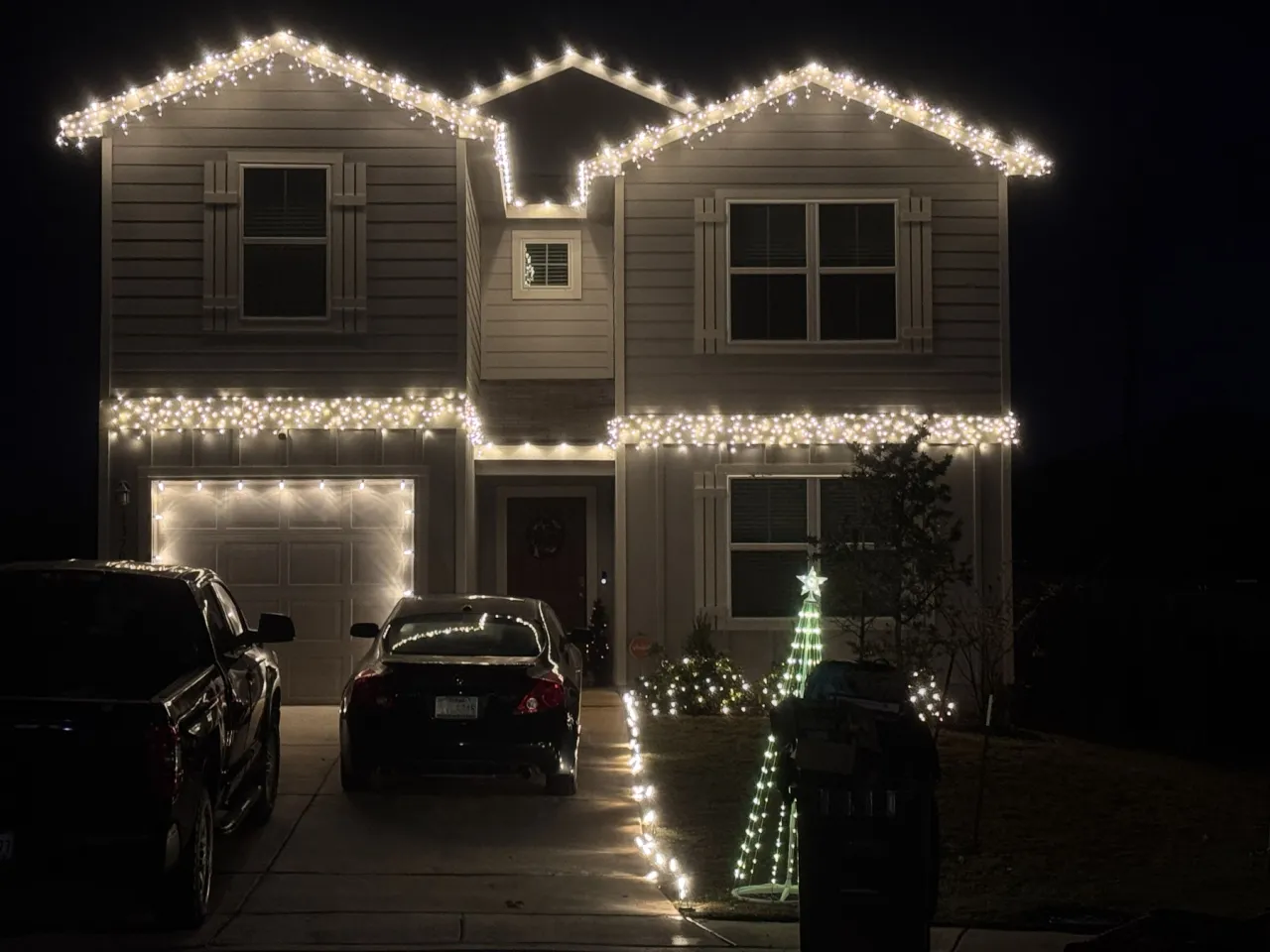 Warm White Icicle Display with Cone Tree, icicle holiday lighting installation by Brilliance Lighting
