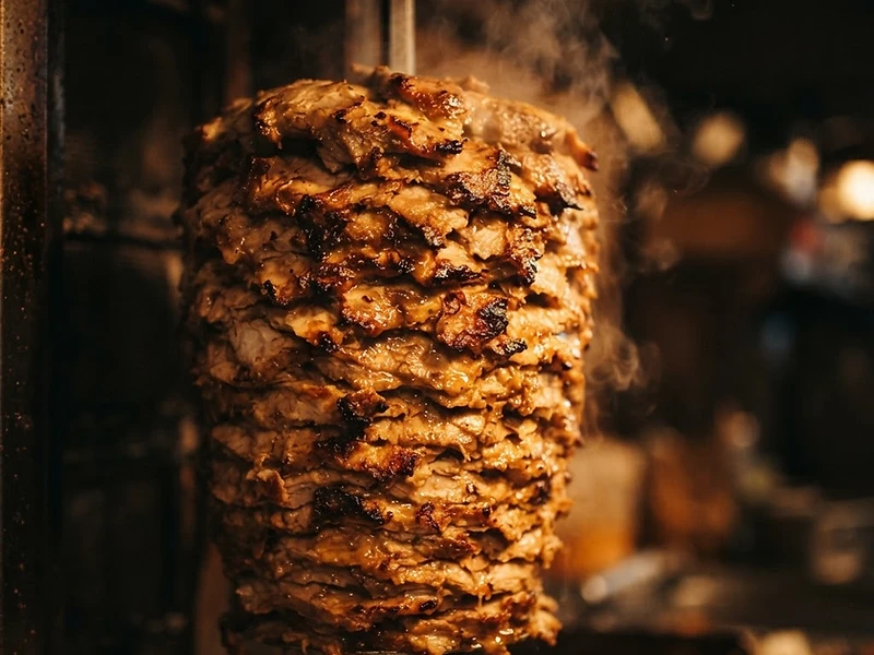 Gyro meat roasting on a vertical spit