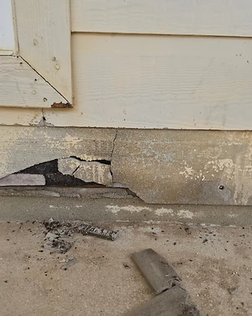 Damaged exterior siding beneath a window before repair in San Antonio, Texas.