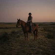 Rider and horse on the ridge. End of day.