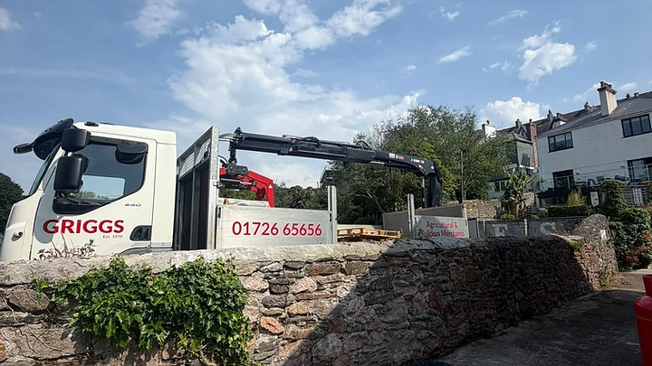 Materials delivery on site beside a dry-stone boundary wall