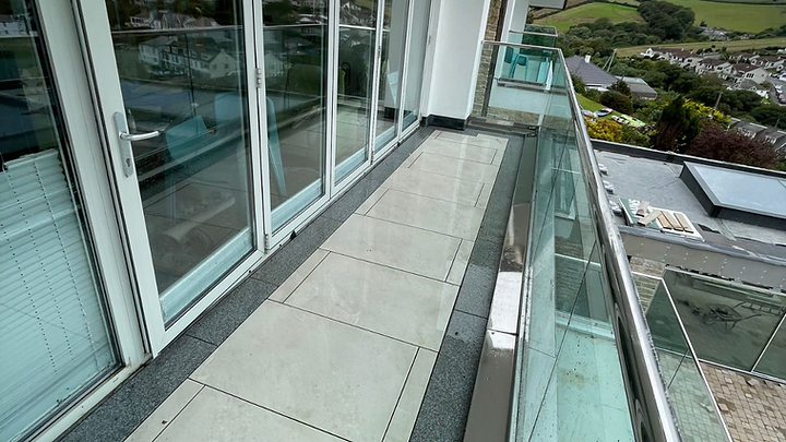 Balcony terrace with glass balustrade overlooking the Cornish coast