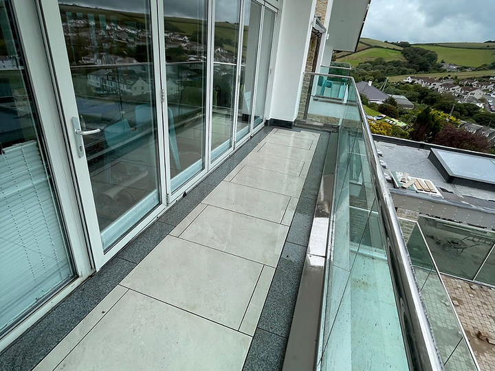 Balcony terrace with glass balustrade and coastal view