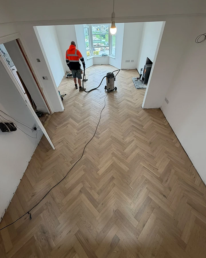 Herringbone oak flooring installation in progress