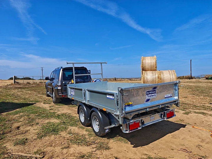 Truck and flatbed trailer loaded on site for groundworks