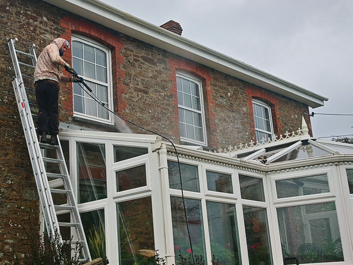 Stone house wall restoration and pressure washing