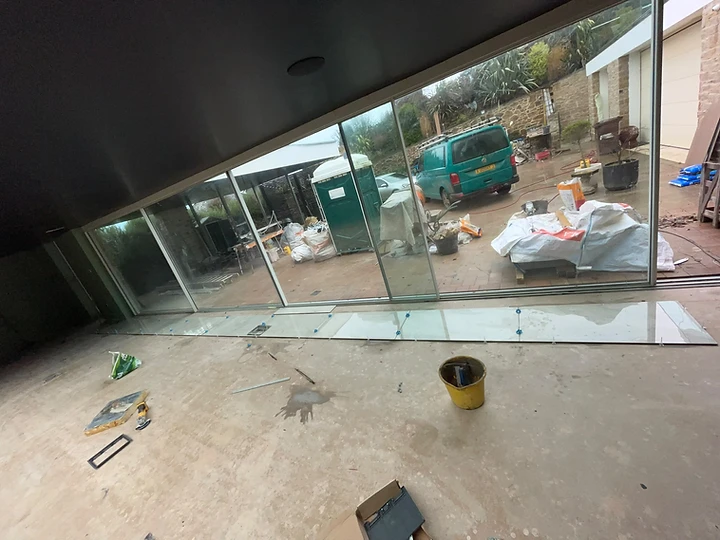 Tiles laid along bi-fold door threshold during an extension build