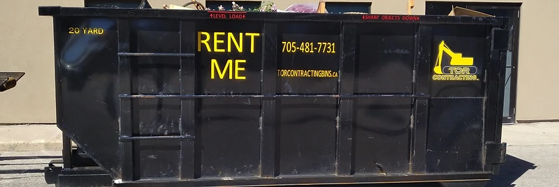 Tor Contracting 20-yard roll-off dumpster loaded with debris