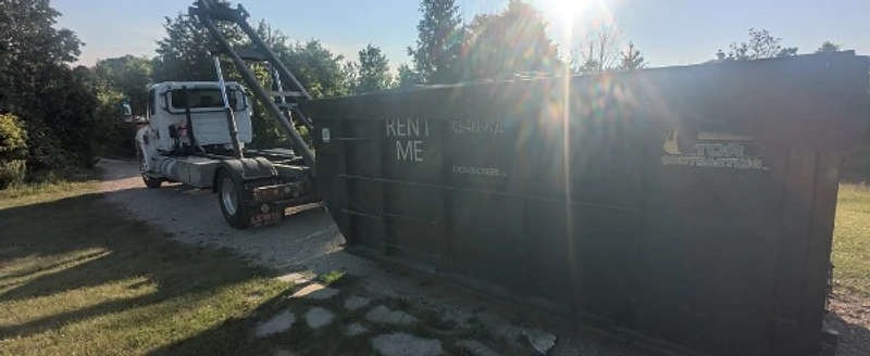 Tor Contracting roll-off truck with a RENT ME dumpster