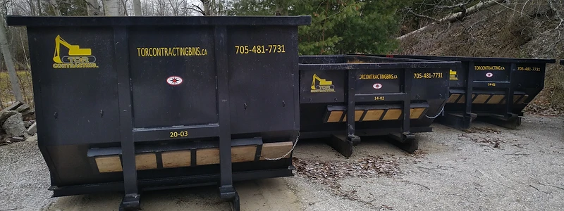 Row of Tor Contracting roll-off bins staged on a lot