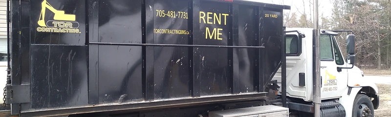 Tor Contracting roll-off truck carrying a dumpster