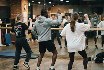 Students trying a K-pop dance in a practice studio