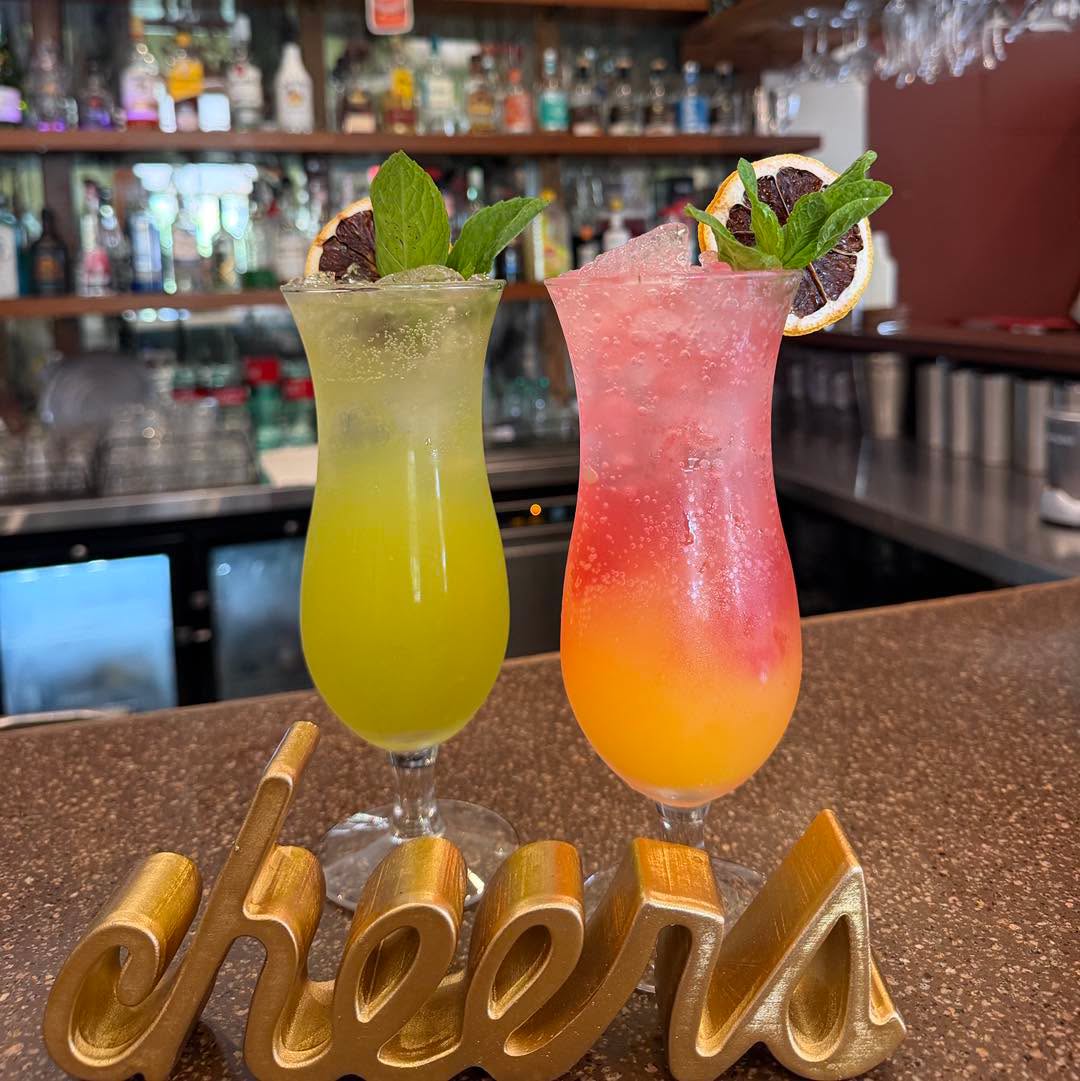 Two cocktails with the cheers sign